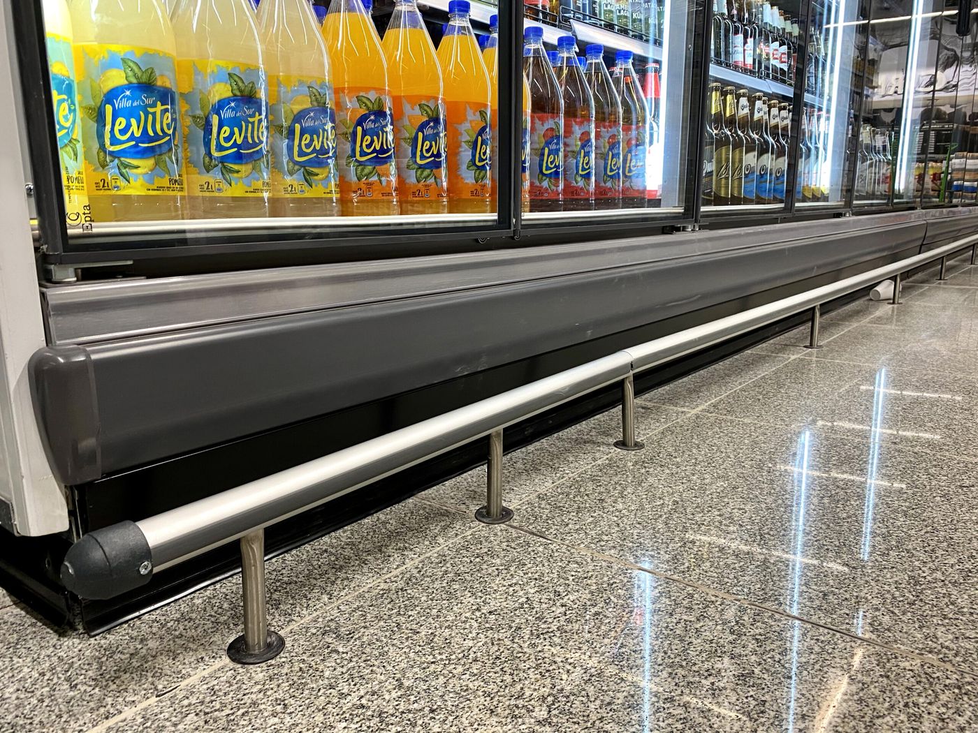 Defensas de acero inoxidable frente a las heladeras de un salón de ventas